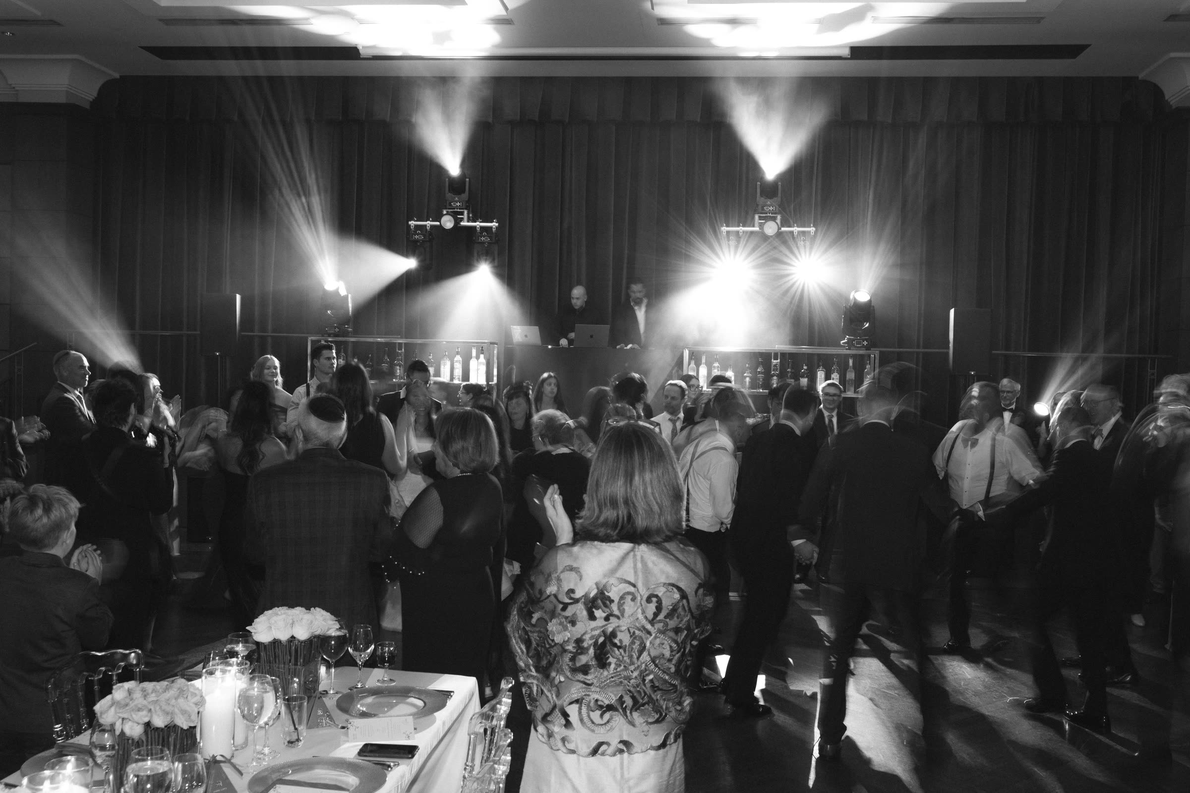 Majd and Kloud behind the booth with moving lights cutting through haze over a full dance floor
